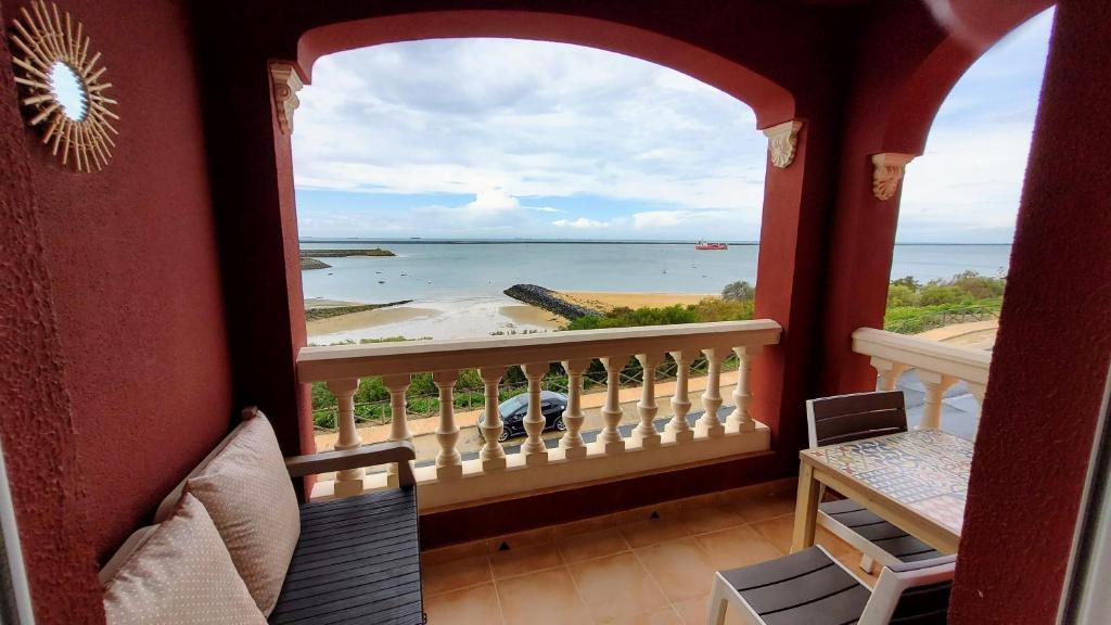 a room with a balcony with a view of the ocean at Estudios Costavigía Mazagón by Ramona in Mazagón