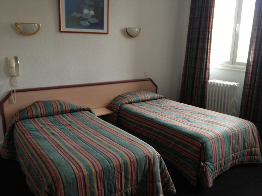 Postel nebo postele na pokoji v ubytování Hôtel de Nevers