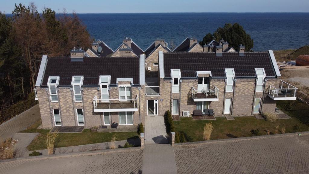 an aerial view of a large house by the ocean at Biały Klif in Mechelinki