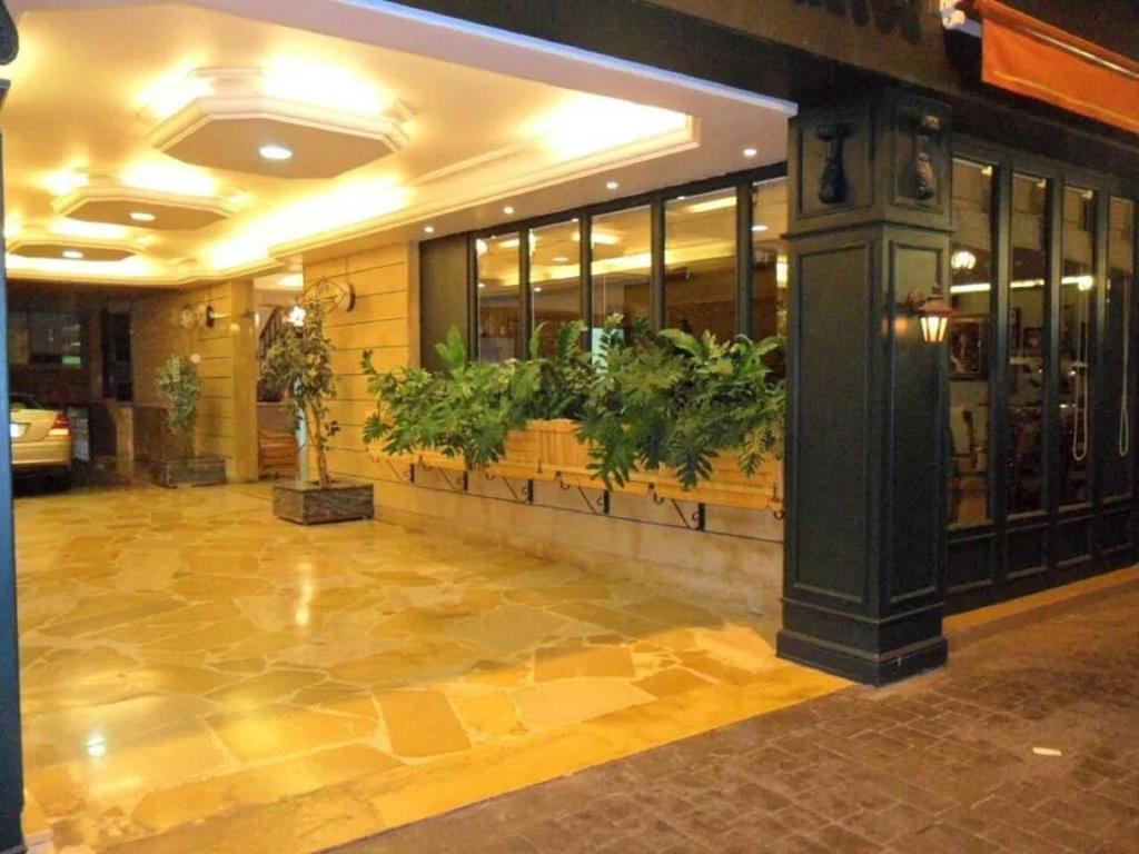 a lobby of a building with plants on the wall at Viccini Suites in Beirut