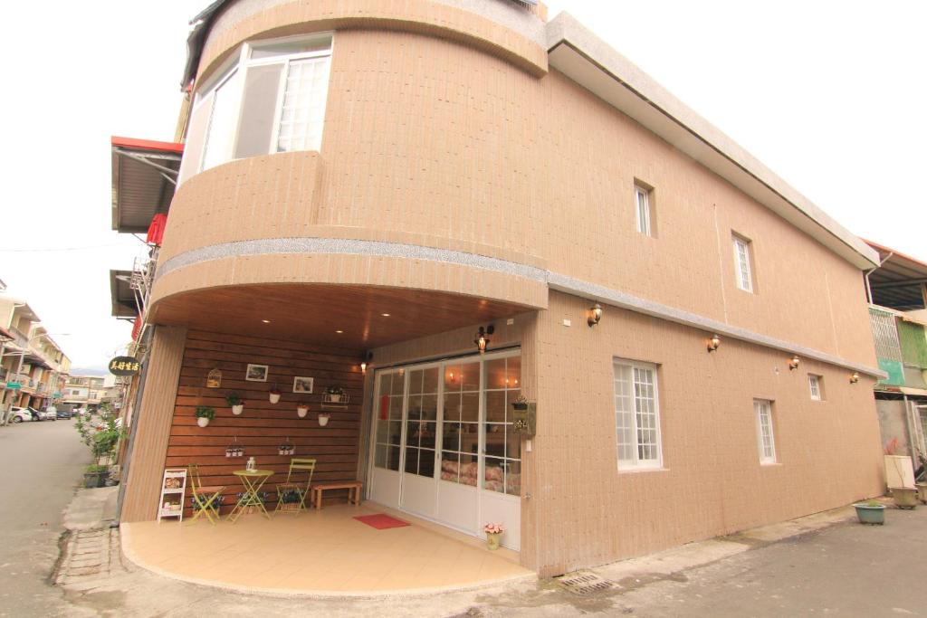 a large brick building with a patio on a street at Beautiful Life B&amp;B in Dongshan