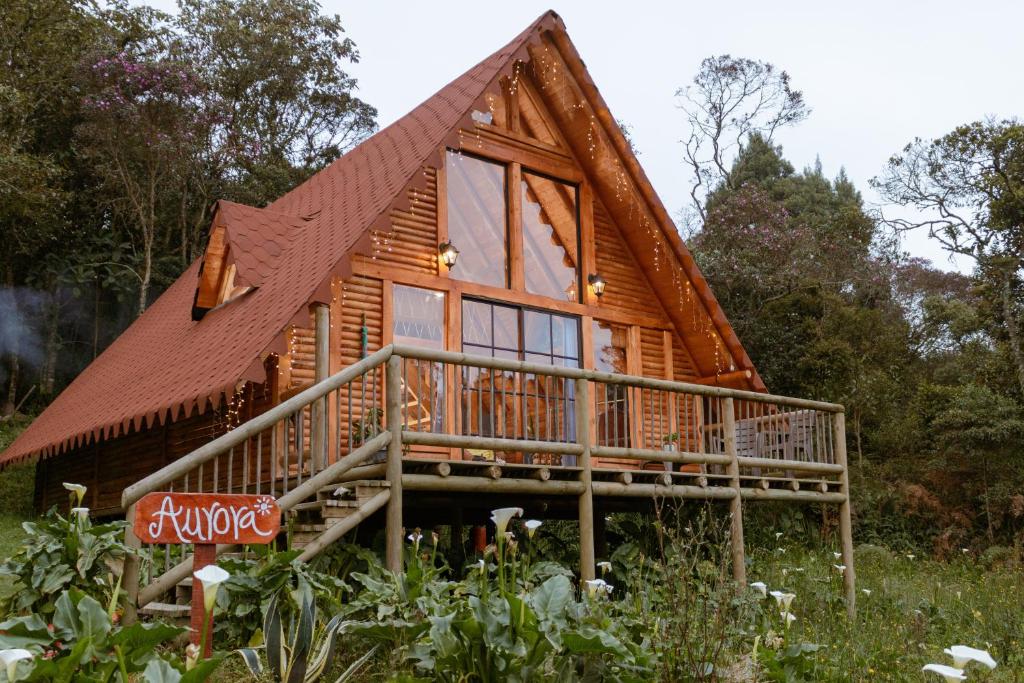 a log cabin with a gambrel roof at BRUMA BLANCA CHALETS in Medellín