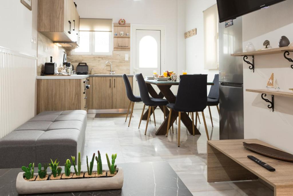a kitchen and living room with a table and chairs at Chrysa House Kissamos in Kissamos