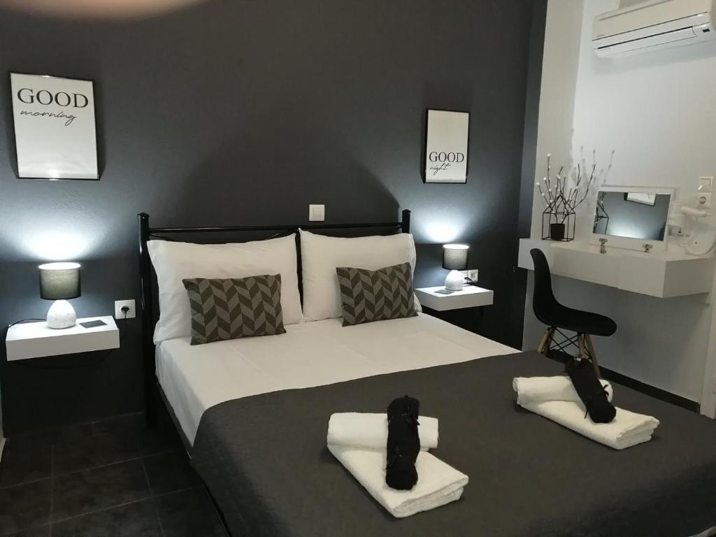 a bedroom with a large bed and a chair at Sabbia Calda 8 by Comfortbnb in Perissa