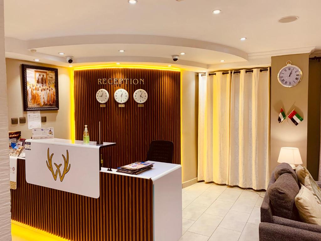 a waiting room with clocks on the wall at Al Rawdha Hotel Apartments in Sharjah