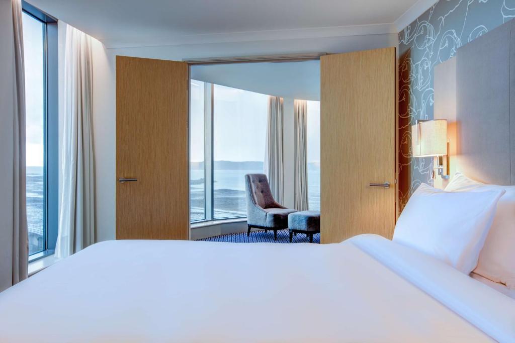 a hotel room with a large bed and a window at Radisson Blu Waterfront Hotel, Jersey in Saint Helier Jersey