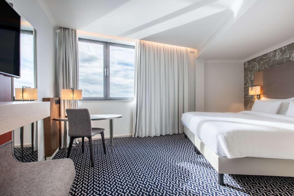 a hotel room with a bed and a desk at Radisson Blu Waterfront Hotel, Jersey in Saint Helier Jersey