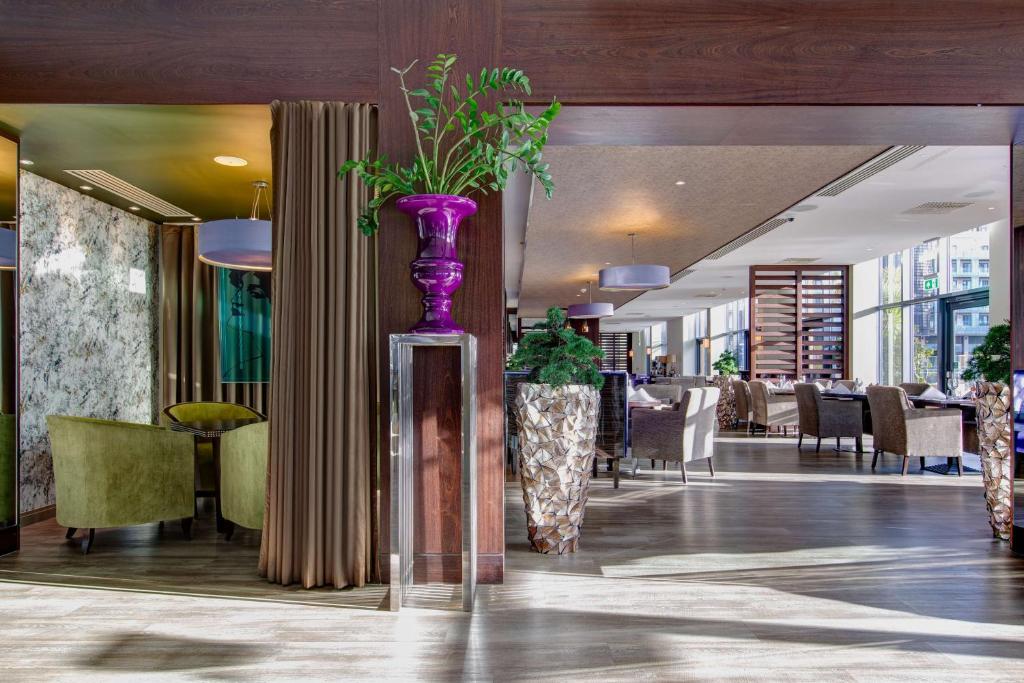 a purple vase with plants in the middle of a restaurant at Radisson Blu Waterfront Hotel, Jersey in Saint Helier Jersey