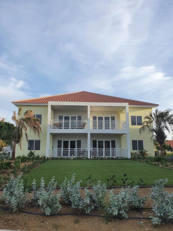 a large house with a lawn in front of it at Cristalina's Little Apartment in Willemstad