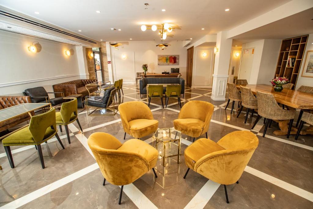 a lobby with chairs and tables in a room at Montefiore Hotel By Smart Hotels in Jerusalem