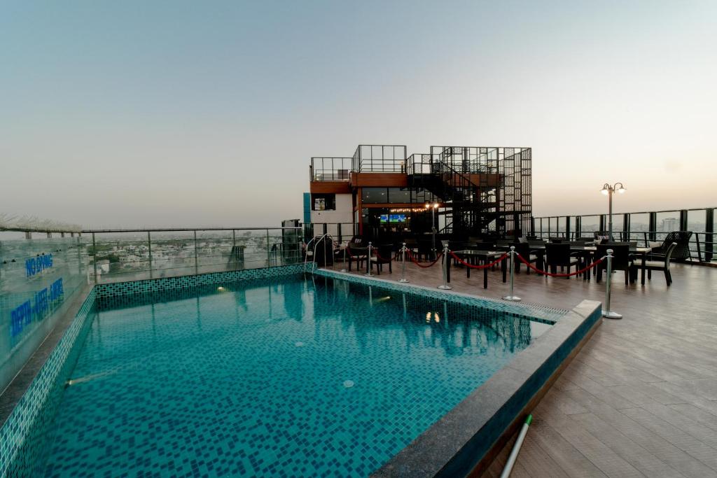 a swimming pool on the roof of a building at Sarovar Portico Jaipur in Jaipur