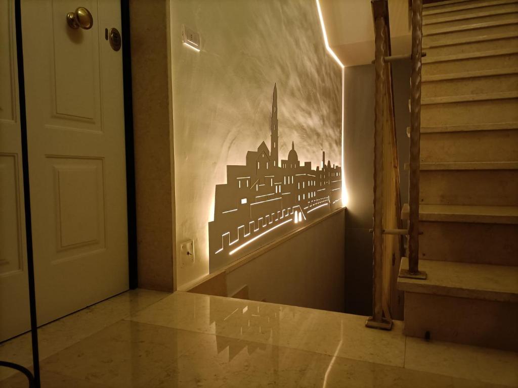 a hallway with a wall mural of a city at Sogno D'Epoca 1822 in Monopoli