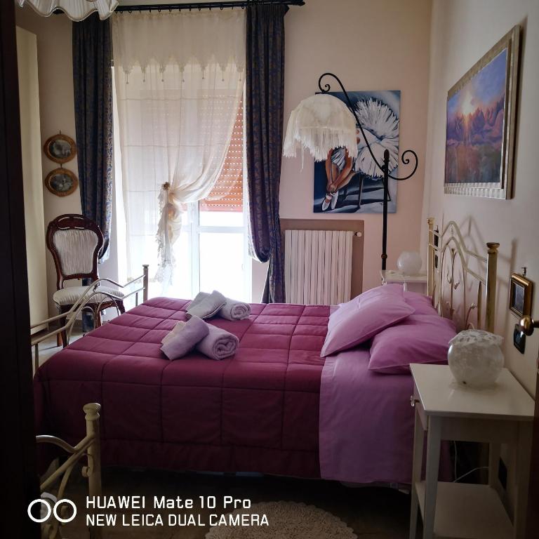 Postel nebo postele na pokoji v ubytování Casa Maddalena family