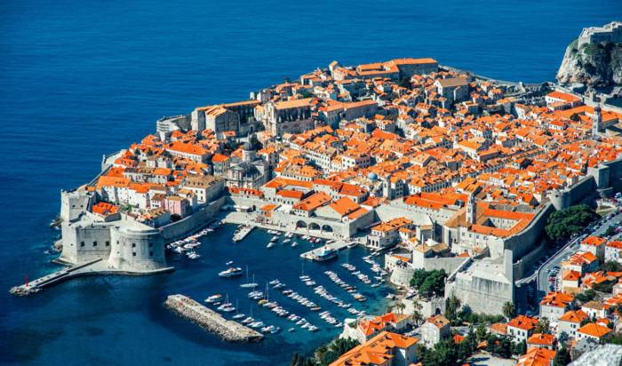 Luftblick auf eine Stadt mit Booten im Wasser in der Unterkunft Dubrovnik Sun Apartment in Dubrovnik