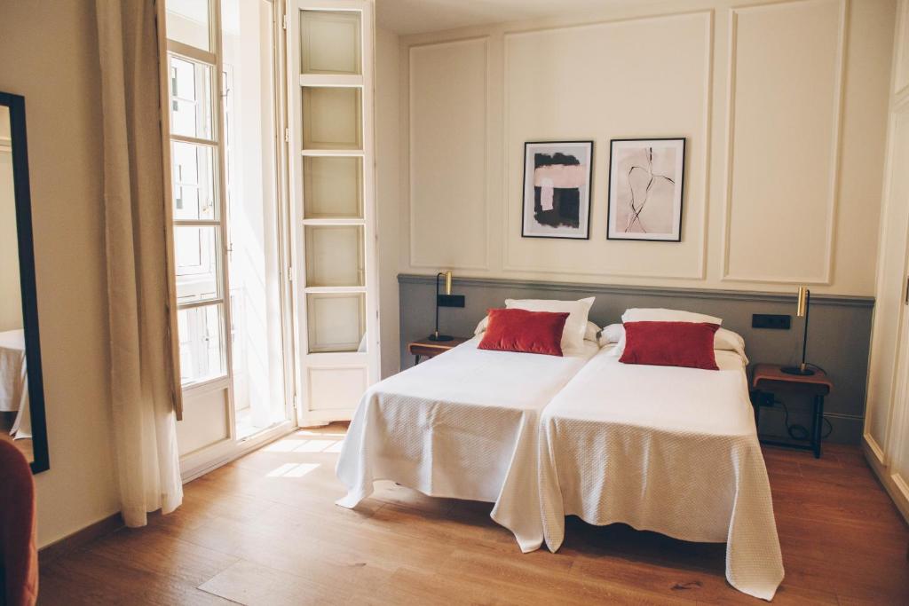 A bed or beds in a room at Alcazaba Premium Hotel