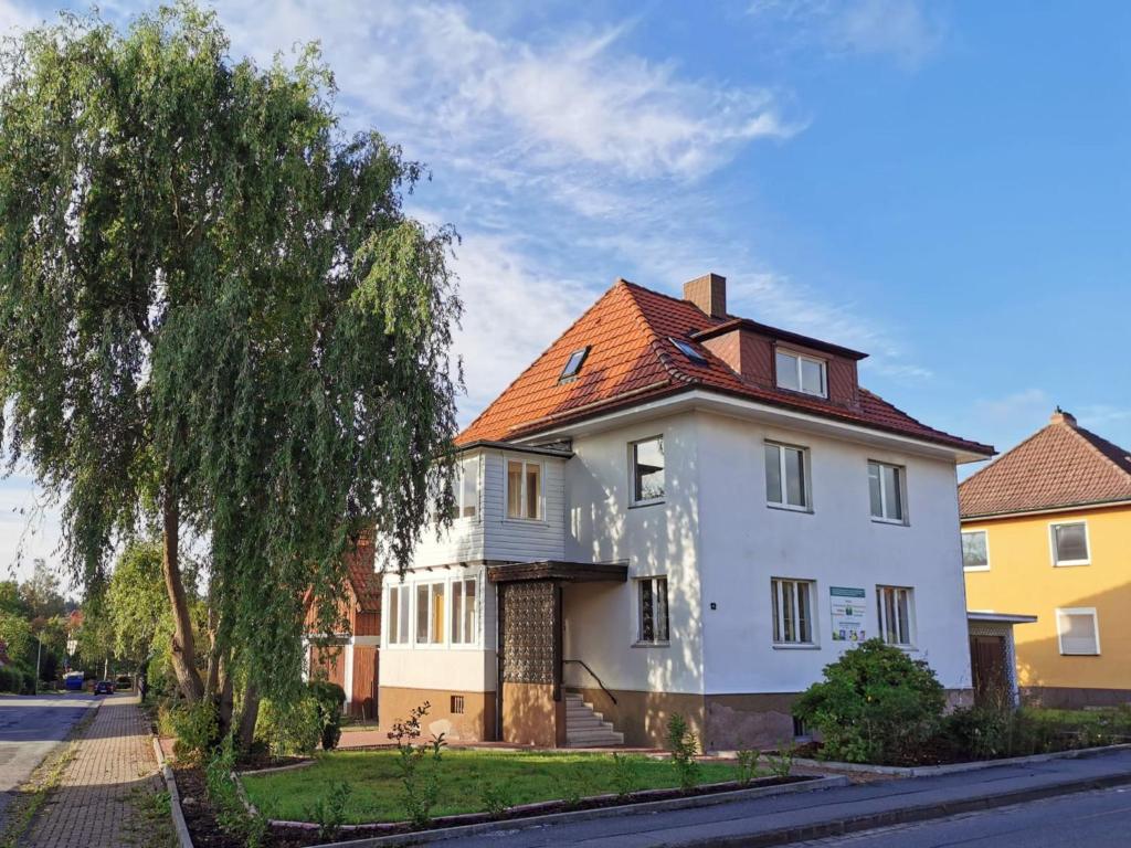 a large white house with a red roof at Ferienwohnung Frieda - a63776 in Bad Sachsa