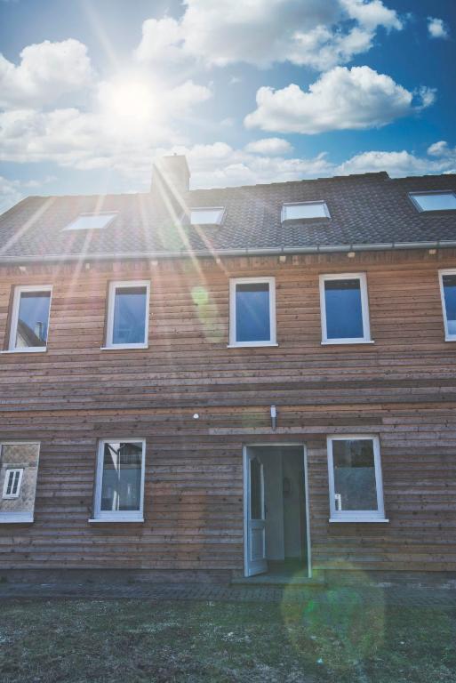 a brick house with the sun shining on it at Ferienhaus Eulenspiegel in Clausthal-Zellerfeld