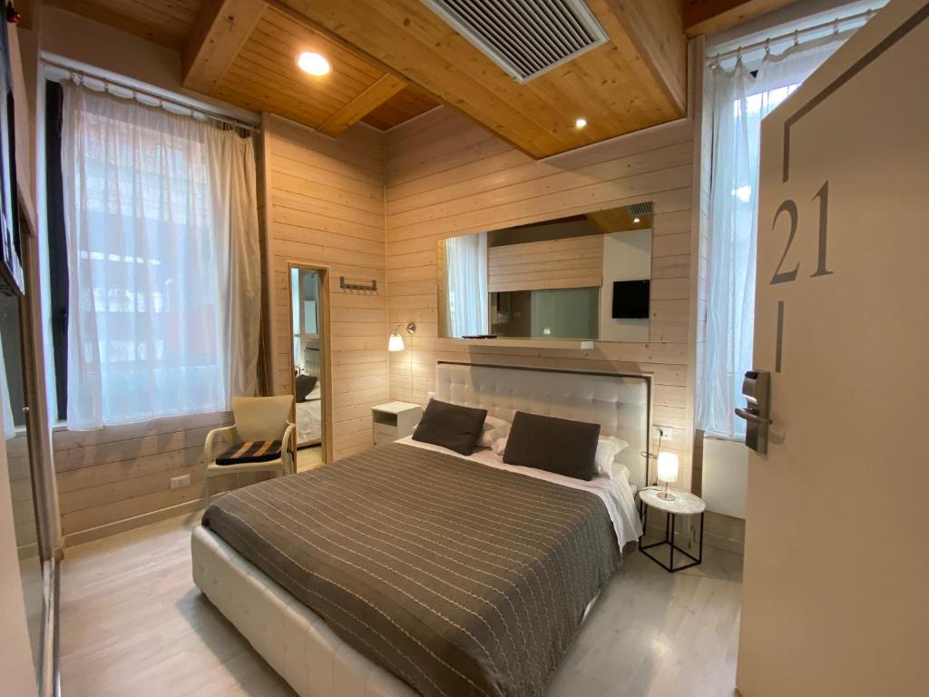 1 dormitorio con 1 cama, 1 silla y TV en White albergo diffuso Ristorante & SPA, en Foggia
