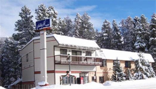 a building with a sign in the snow at Valley Hi Motel in Winter Park