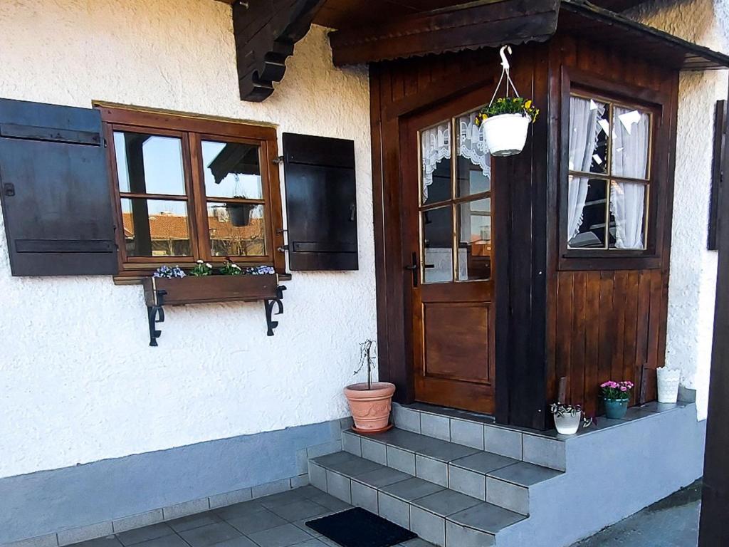 a building with a wooden door and windows at Landhaus Glücksmoment in Rottau