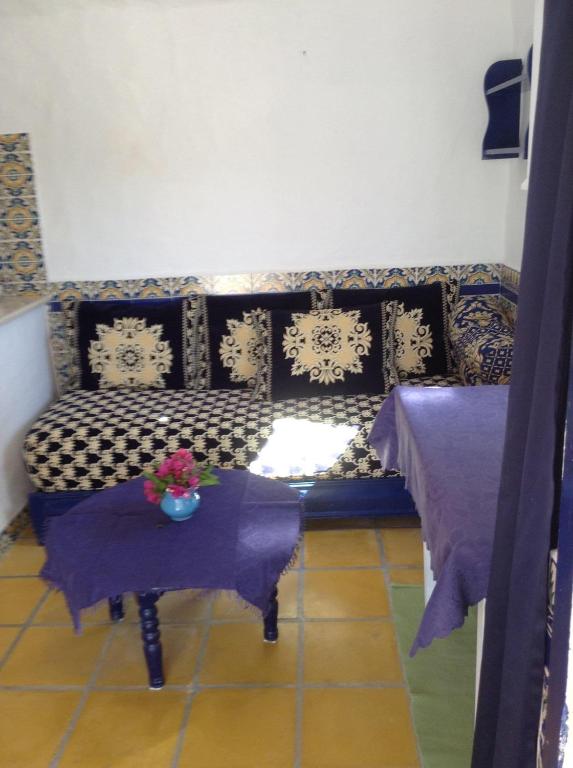 a living room with a couch and a table at RESIDENCE DAR YASMINa in Mezraya