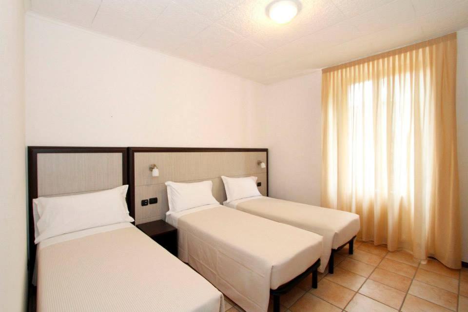 Postel nebo postele na pokoji v ubytování Albergo Maccagno