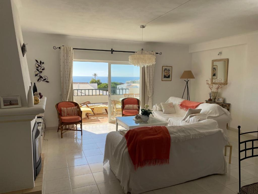 a living room with a bed and a table with a view at Superbe appartement vue sur mer à 180° Luz in Luz