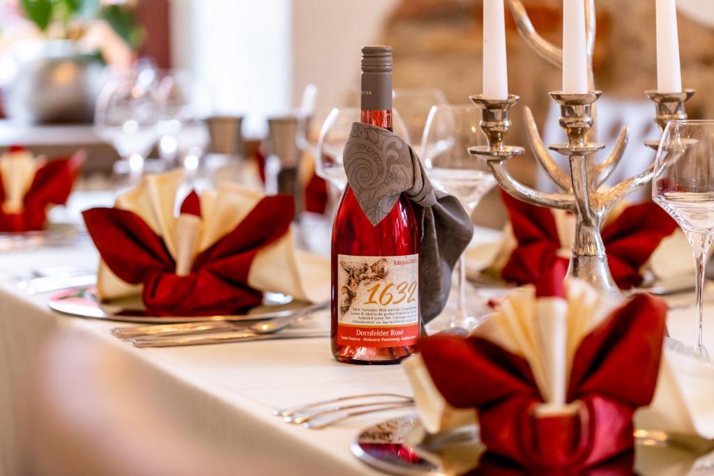 a bottle of wine sitting on top of a table at Ringhotel Jägerhof in Weißenfels