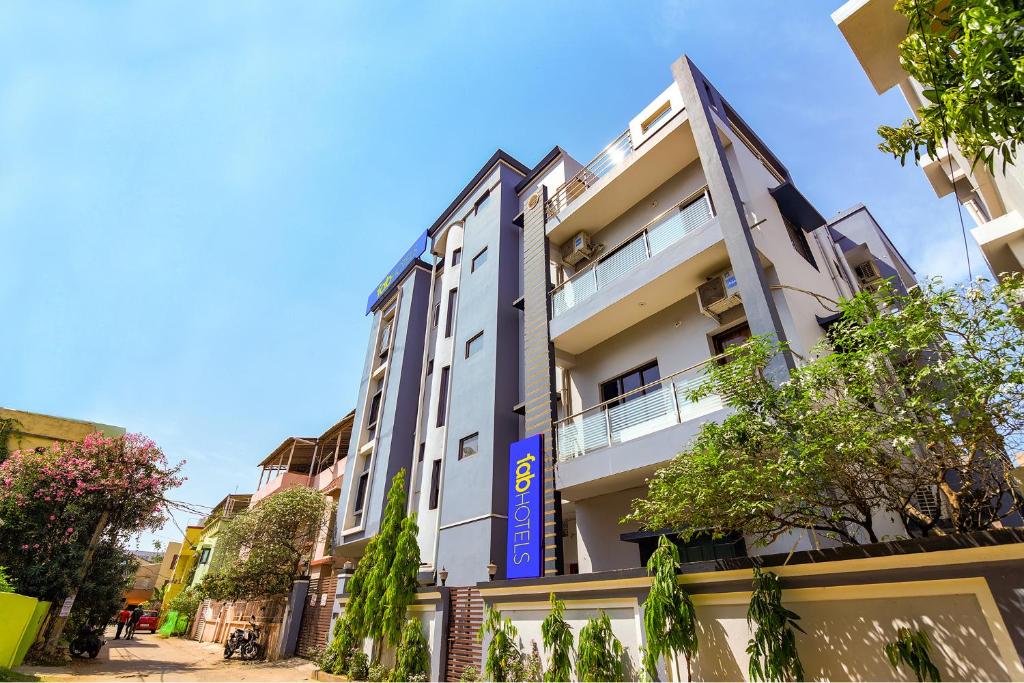 a white building with a blue sign on it at FabExpress Crystal Stay in Bhubaneshwar