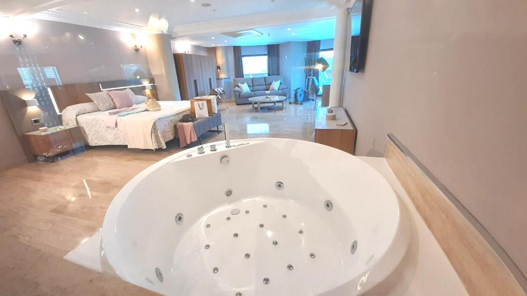 Postel nebo postele na pokoji v ubytování Hotel Nueva Plaza
