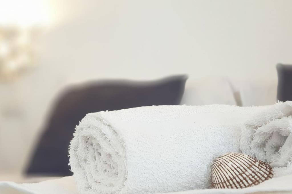 a pile of towels sitting on top of a bed at RgB_Apartments in Lampedusa