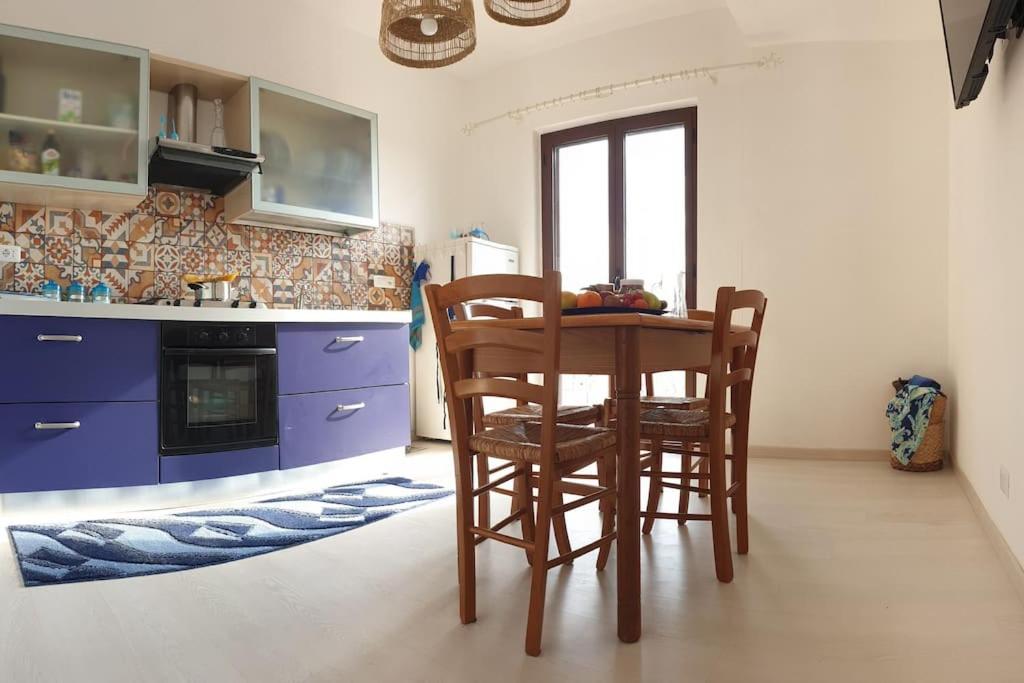 a kitchen with a table and two chairs in it at RgB_Apartments in Lampedusa