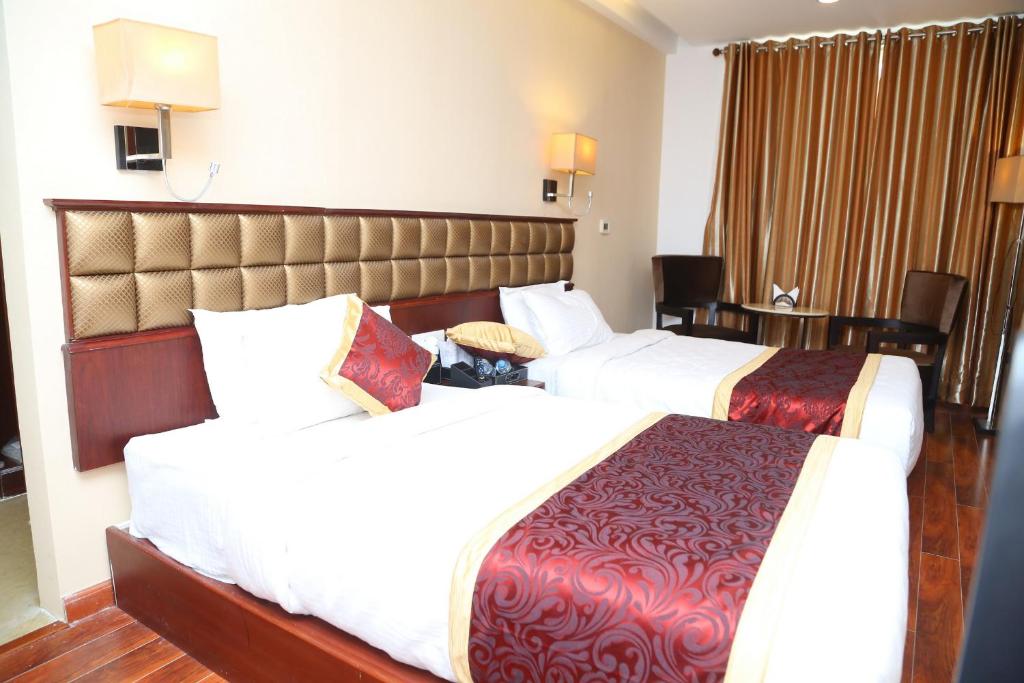 Postel nebo postele na pokoji v ubytování Raaj Bhaavan Clarks Inn Chennai