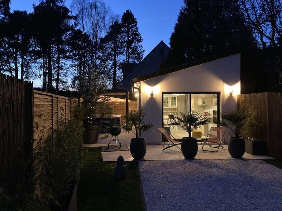 a home with a patio with plants and lights at SPA & SERENITE, aux Portes de Disney et de Paris in Villiers-sur-Morin