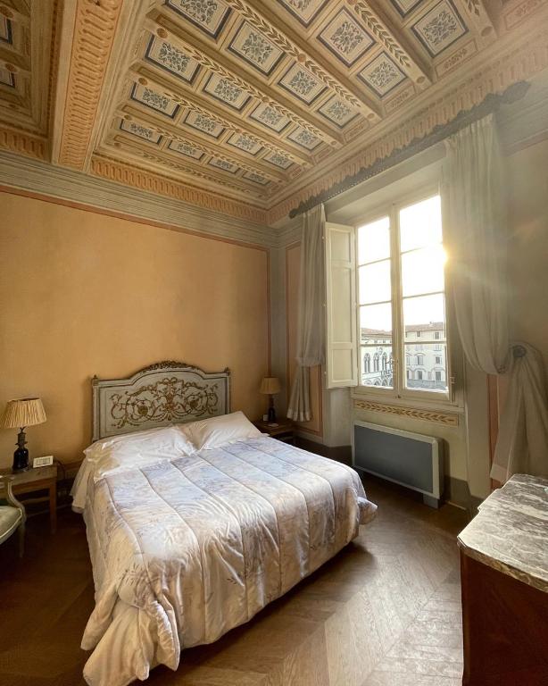 Postel nebo postele na pokoji v ubytování Palazzo Rocchi - Residenza D'Epoca