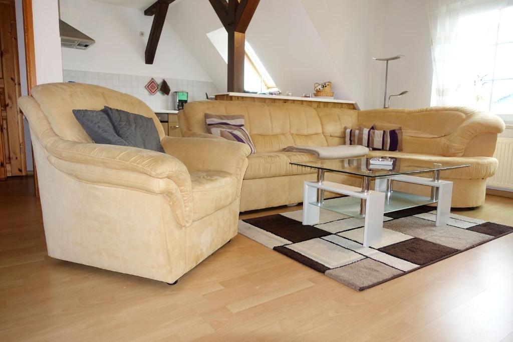 a living room with a couch and a coffee table at FeWo Windrose in Gollwitz