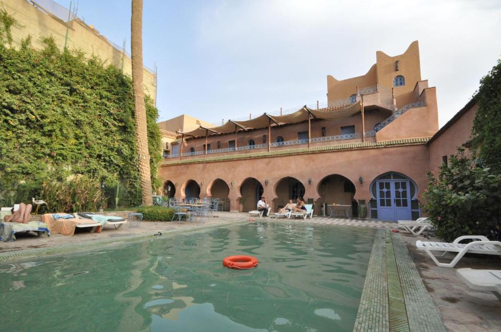 a swimming pool with a red frisbee in the water at Riad Dar Dzahra in Taroudant