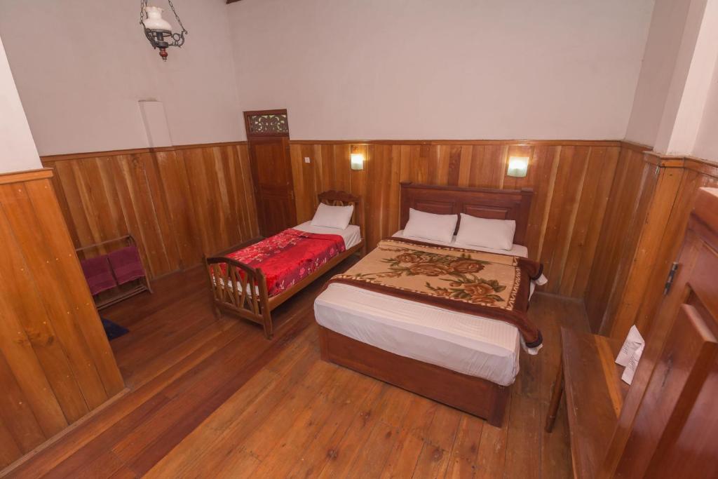 Postel nebo postele na pokoji v ubytování Wathsala Inn