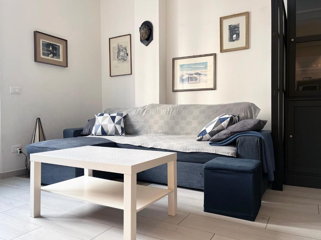 a living room with a couch and a table at The Lighthouse - Central Apartment Aosta - cir 0234 in Aosta