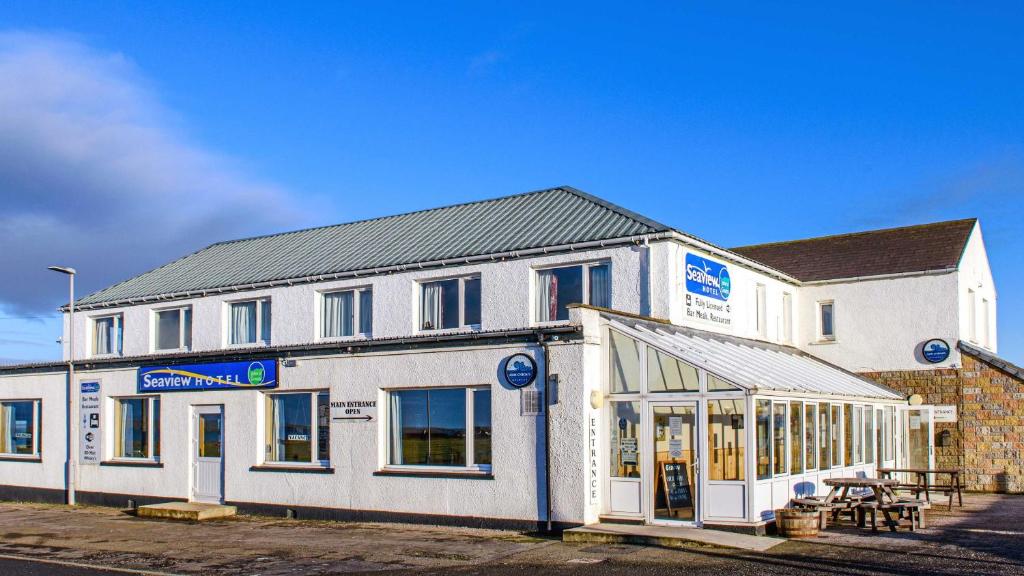 a building with a sign on the front of it at Seaview Hotel in John O Groats