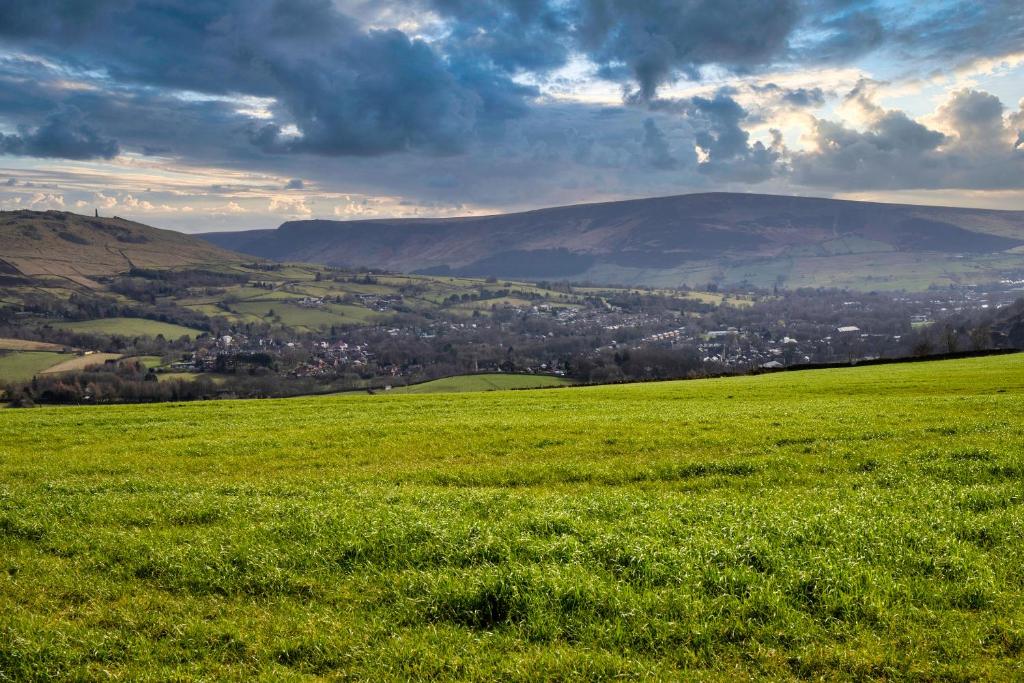 a green field with a city in the distance at THE VIEW! in Delph