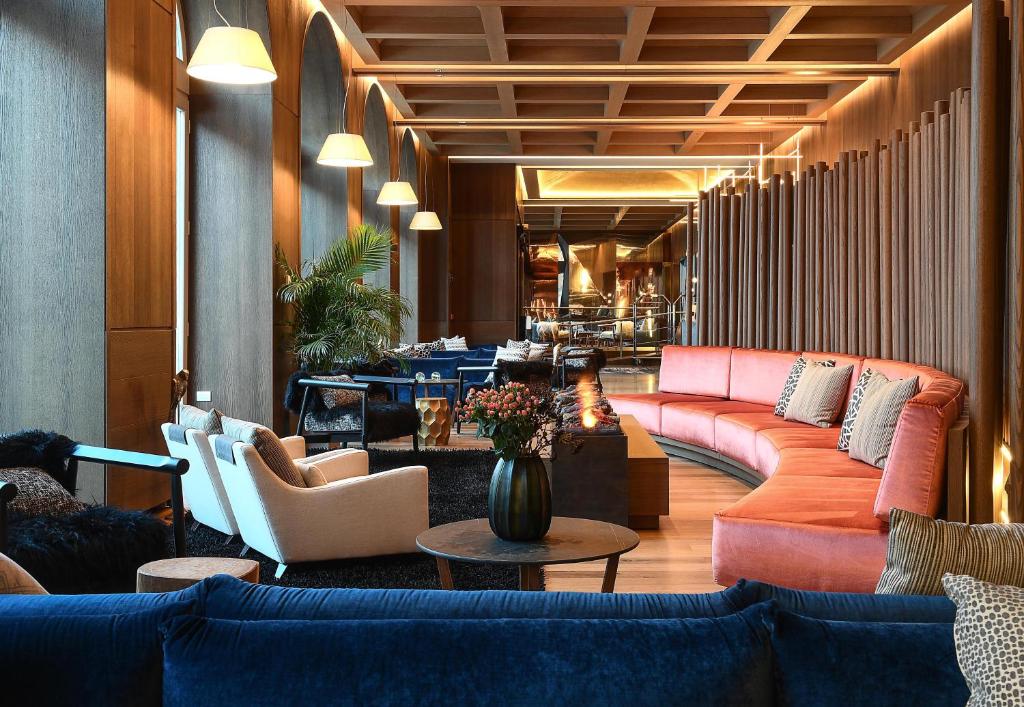 a lobby with couches and chairs and a table at Grand Hotel Savoia Cortina d'Ampezzo, A Radisson Collection Hotel in Cortina dʼAmpezzo
