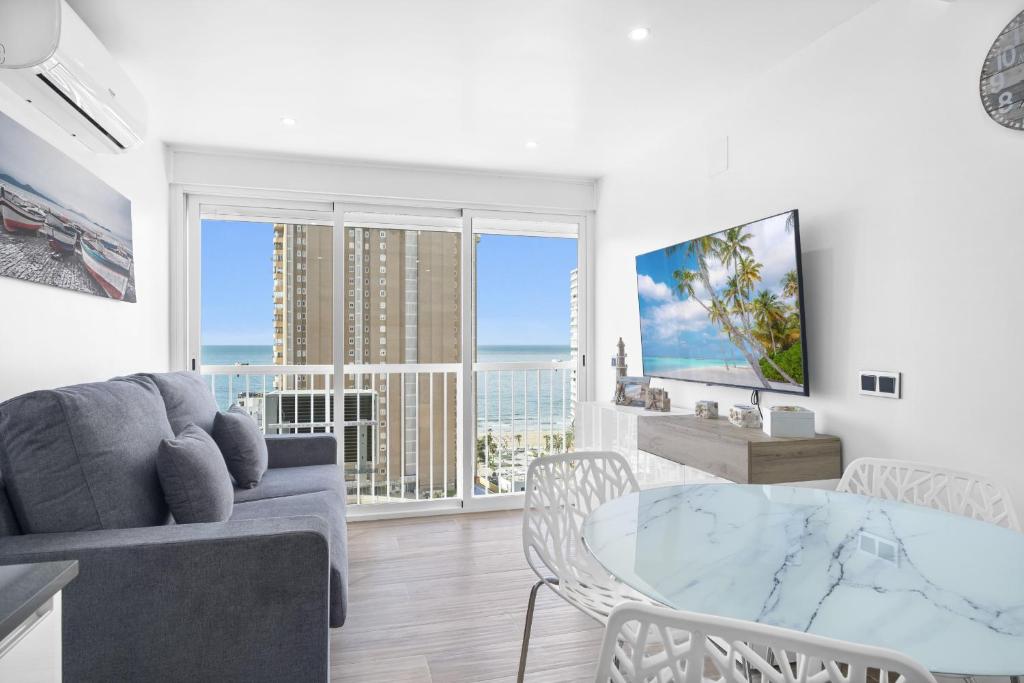 a living room with a couch and a glass table at Albatros Deluxe 15-5 Apartment Levante Beach in Benidorm