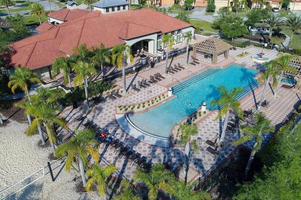 an overhead view of a swimming pool with palm trees at Huge 6Br 6Bath Villa & Private pool Min to Disney in Kissimmee