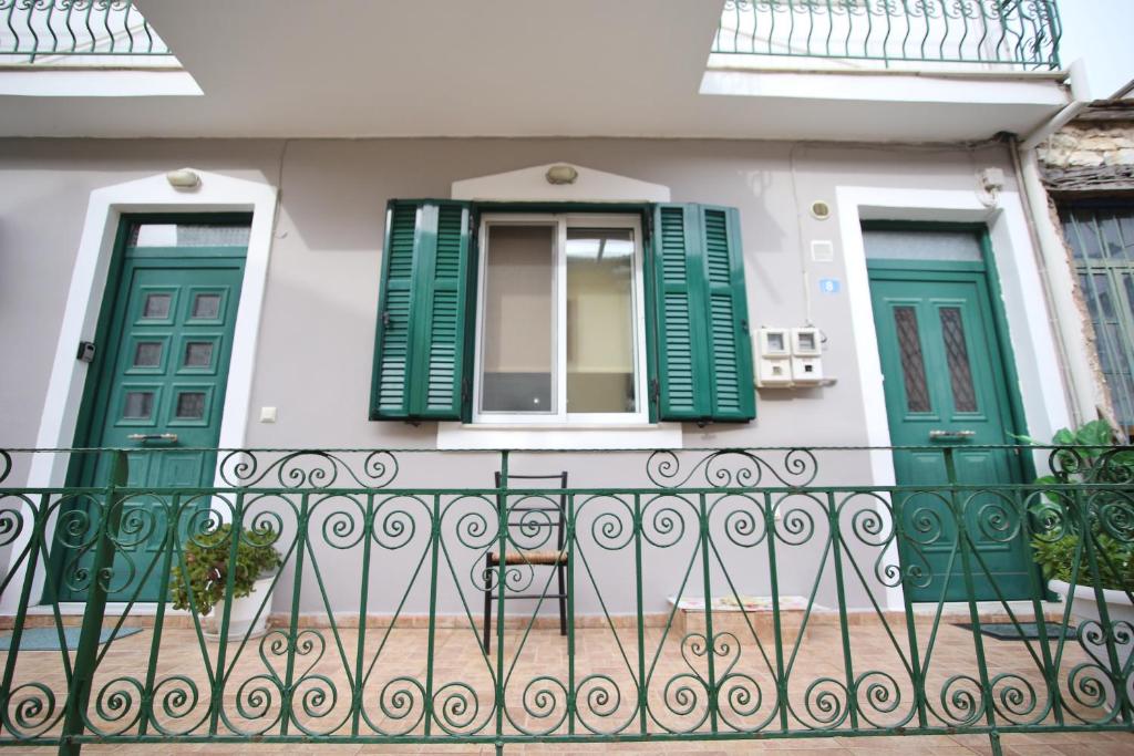 a house with green doors and a fence at Anna's House in Vlikhon