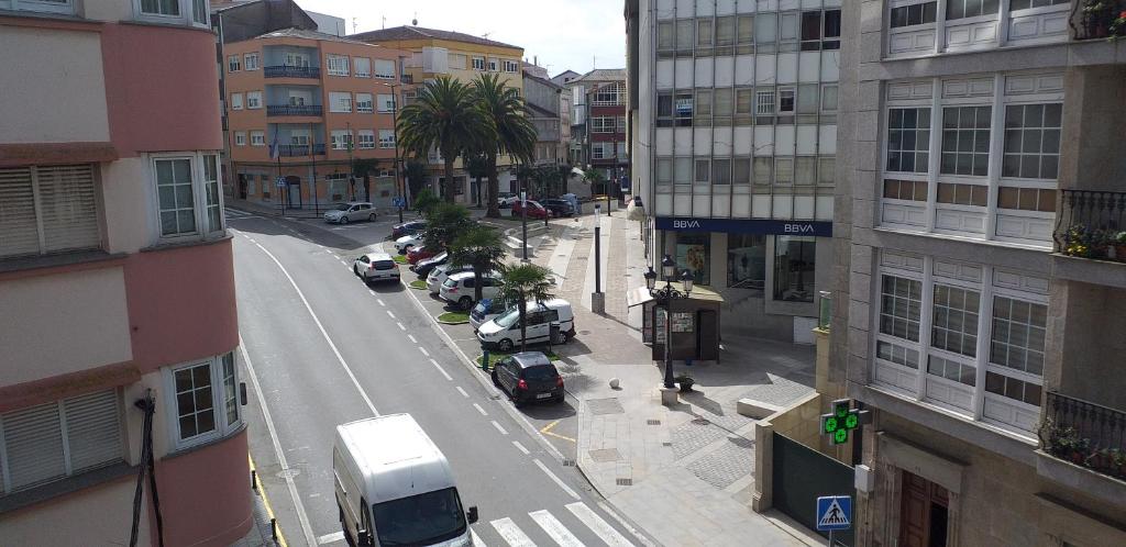 a city street with cars parked on the street at APARTAMENTOS DON MANUEL D in Cee