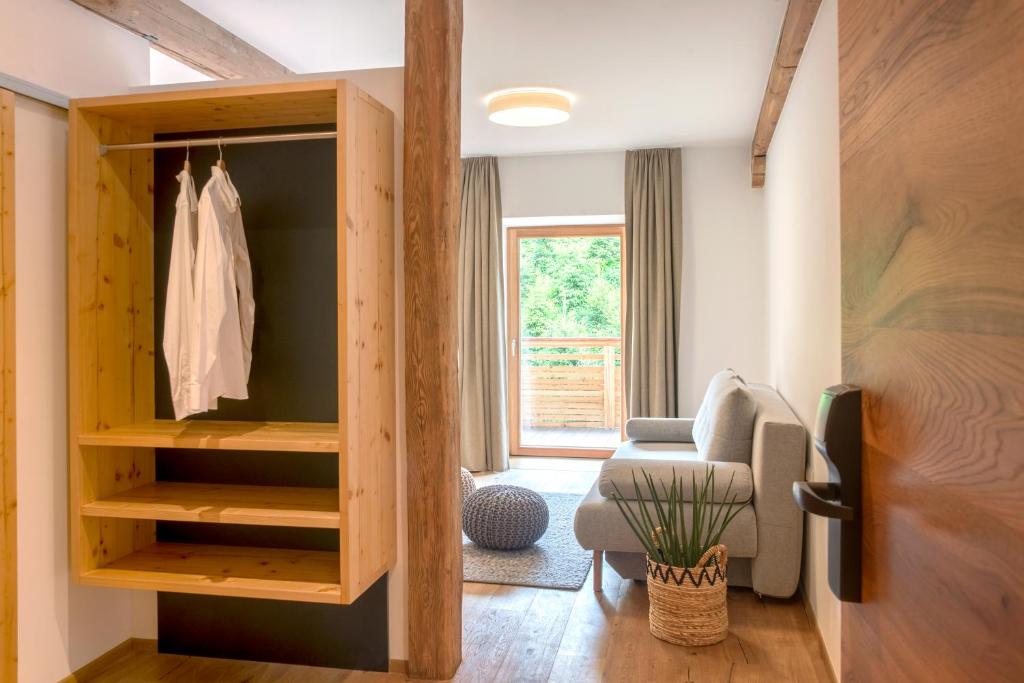 a living room with a closet and a chair at Hotel Gasthof Hirschentenne in Stams