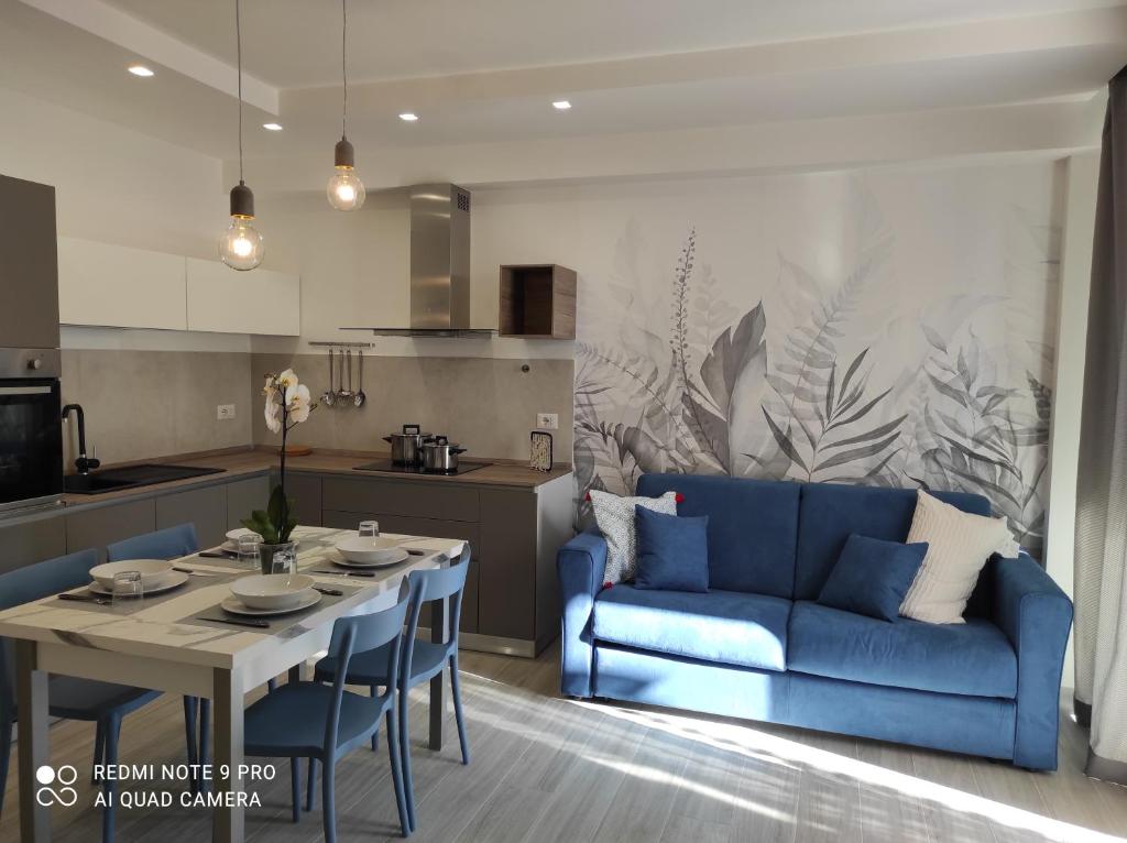 a living room with a blue couch and a table at BLU apartment in Civitanova Marche