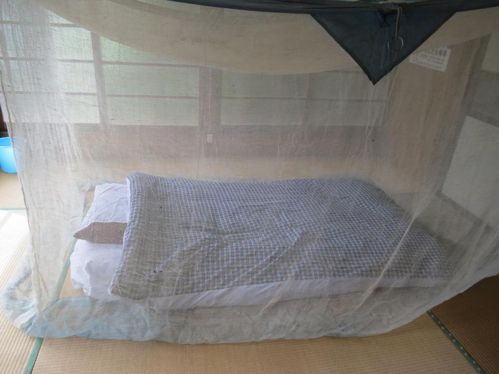 Postel nebo postele na pokoji v ubytování Guesthouse Nishiki