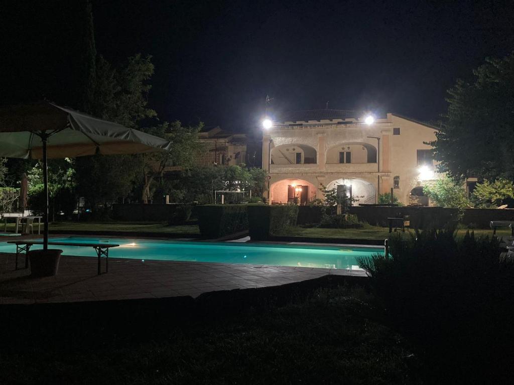 a swimming pool in front of a house at night at Masseria Le Zavattole in Sasso
